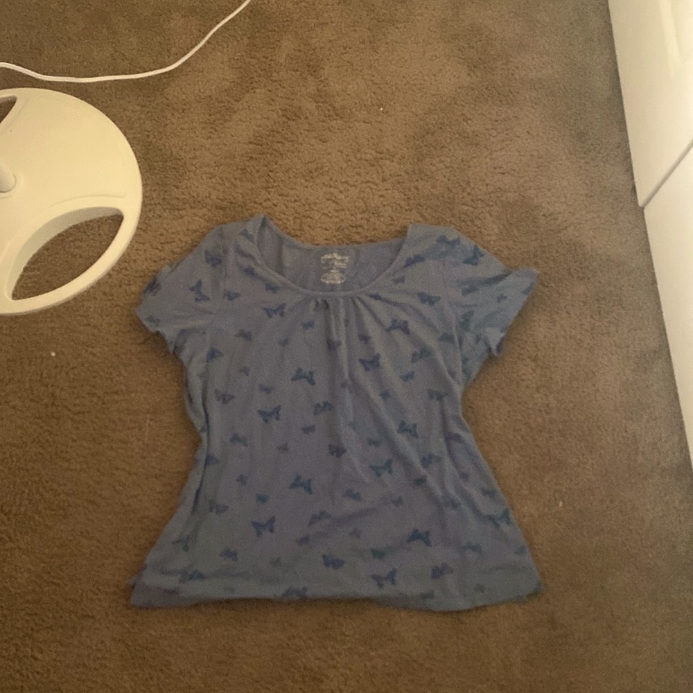 A cute, blue, buttery top. The size is 18-20. The brand is  “Venezia.”